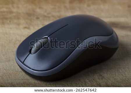 Wireless computer mouse on wooden table