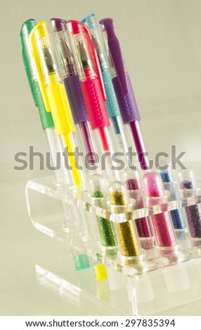 Set of pens in support on gray background