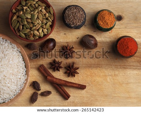 Rice, spice powders and seeds on the wooden table. Top view
