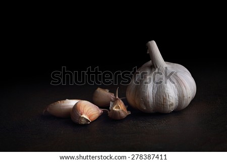 Garlic cloves on the black table. Black background