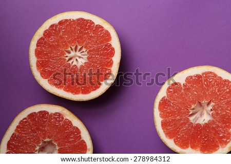 Grapefruits on bright lilac background. Top view