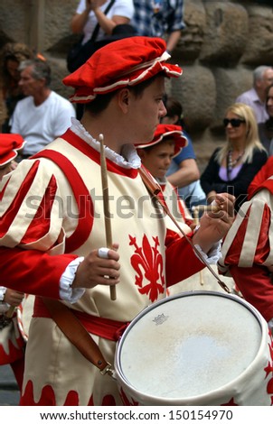 FLORENCE, TUSCANY, ITALY - JUNE 24, 2009: Drummer dressed in medieval clothes walks in the Historical Football Parade in Florence.