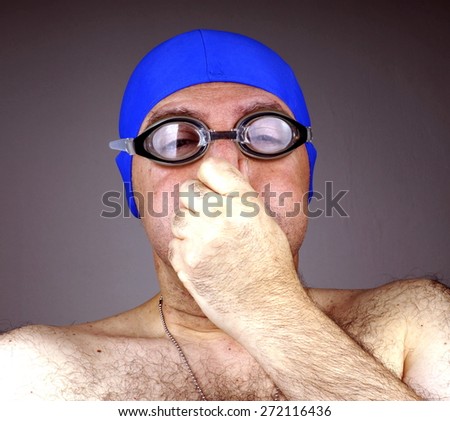 Man with blue swimming cap and goggles