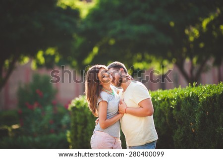 Young couple in love outdoor.Stunning sensual outdoor portrait of young stylish fashion couple posing in summer on nature
