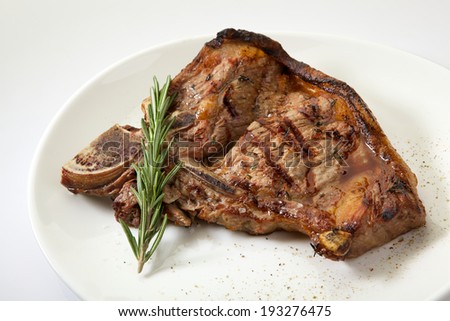 Appetizing grilled rib isolated on white background. Grilled mutton rib with blood