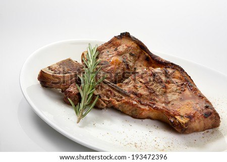 Appetizing grilled rib isolated on white background. Grilled mutton rib with blood