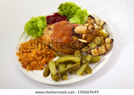 Appetizing Pork leg with vegetables isolated on white background