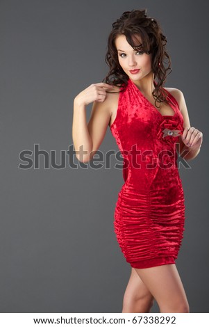 stock photo The beautiful girl in a red velvet dress with wavy hair