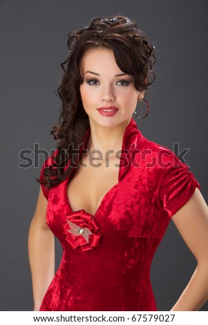 stock photo The beautiful girl in a red velvet dress with wavy hair
