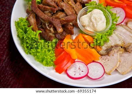 Appetizing meat and vegetable all sorts with sauces and greens