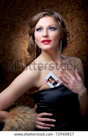 Queen of poker: a heart. The charming girl with a card.
