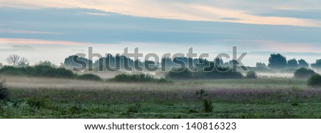 Panoramic photo of a morning fog in a valley