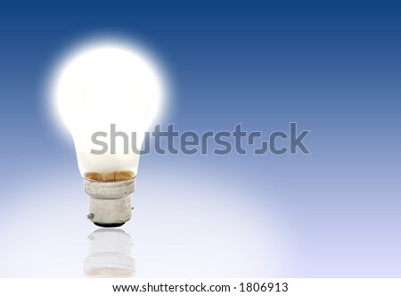 lit light bulb with grad blue background and light reflection
