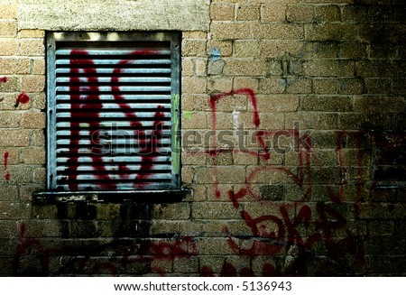 grungy wall with graffiti tag at night