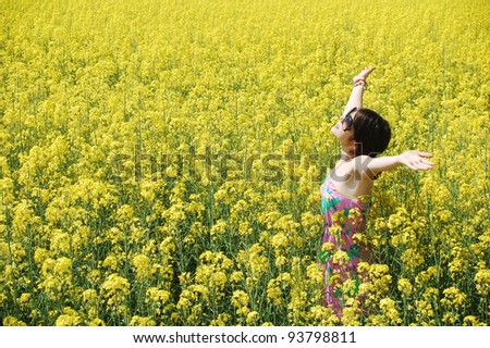 Young caucasian woman in a sea of flowers