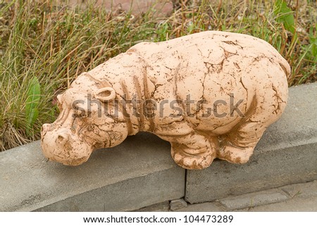 Ceramic sculpture of a hippopotamus with a glaze in the garden