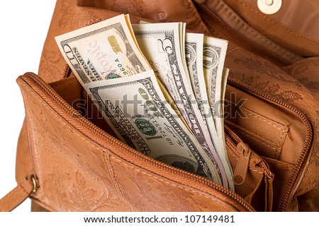 U.S. dollars in the pocket of the open women\'s handbags