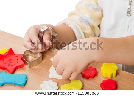 Hands of a Child make figurines of modeling clay