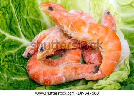 Heap frozen shrimp on cabbage leaf