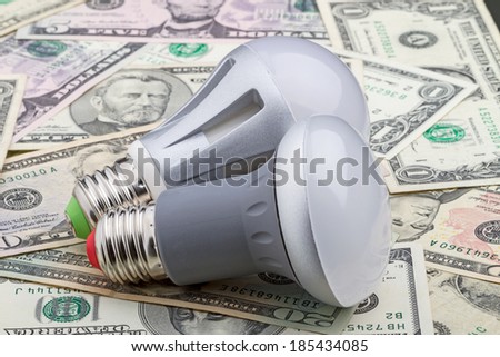 Two LED electric bulb with an E27 base on dollar. 90% saving money