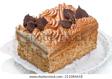 Layer cake with ground nuts on a white plastic plate