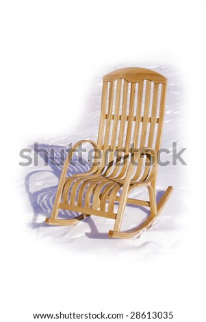 Wooden rocking chair in the snow. Winter sunny day.