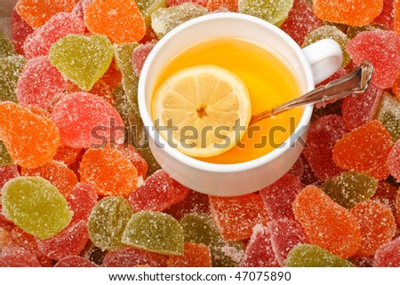 A cup of tea with lemon and Fruit jelly background