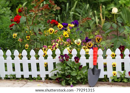 Blooming Fence of Flowers. A small flower bed near the house