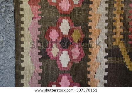 Detail of the border of the wool rug with geometric pattern