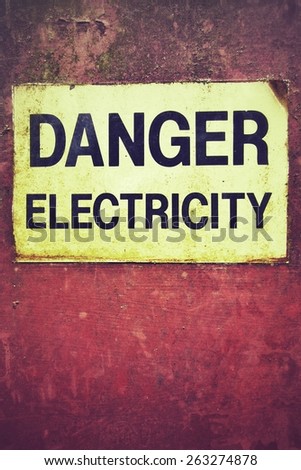 Danger electricity warning sign on old rusty metal plate, box.
