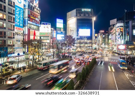 TOKYO, JAPAN - DECEMBER 19, 2014: Pedestrians walk at Shibuya Crossing during the holiday season, one of the busiest crosswalks in the world.