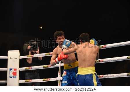 Kyiv, UKRAINE - March 20, 2015 : Hu Jianguan (China)  and VUSENALIEV Azat (UA) in the ring during boxing fight Ukraine Otamans vs China Dragons in Palace of Sport in Kiev, Ukraine