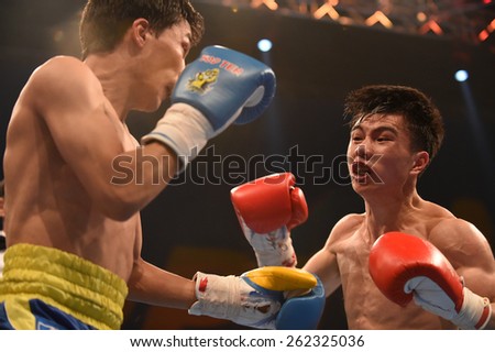 Kyiv, UKRAINE - March 20, 2015 : Hu Jianguan (China) and VUSENALIEV Azat (UA) in the ring during boxing fight Ukraine Otamans vs China Dragons in Palace of SPport in Kiev, Ukraine