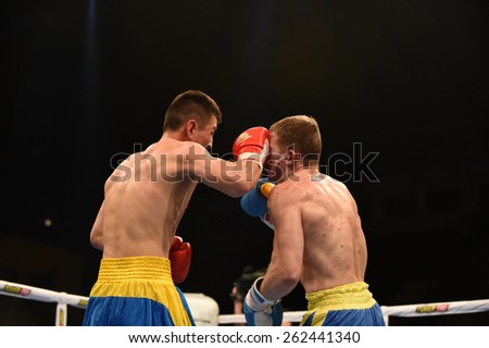 Kyiv, UKRAINE - March 20, 2015 : ZUBENKO Oleg (UA) and HAISHAER Taximaimaiti (China) in the ring during boxing fight Ukraine Otamans vs China Dragons in Palace of Sport in Kiev, Ukraine