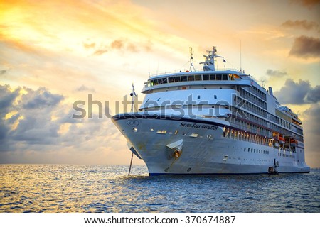 St. Barts, November 25, 2015: Beautiful marine view with one large cruise liner ship called Regent Navigator of Regent Seveneseas cruise line in port on sunset background, horizontal picture