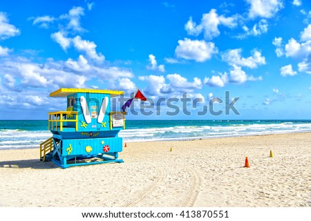 South Beach, Miami, Florida, lifeguard house in a colorful Art Deco style on cloudy blue sky and Atlantic Ocean in background, world famous travel location