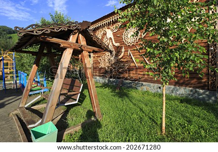 Wooden swing on the territory of the Tourist complex \
