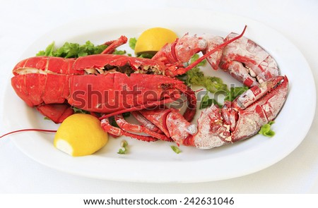 Cooked lobster on a white plate in a restaurant.