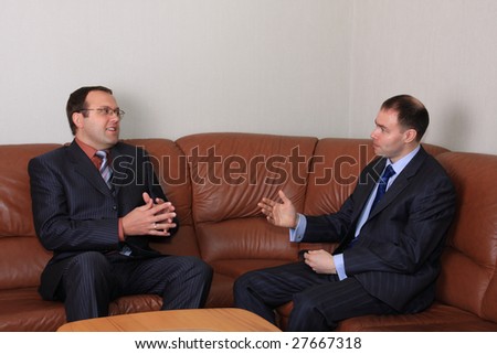 Business negotiations of two businessmen are in an office.