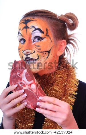 Girl tiger with the piece of raw meat. On an east calendar New 2010 year - year of tiger.