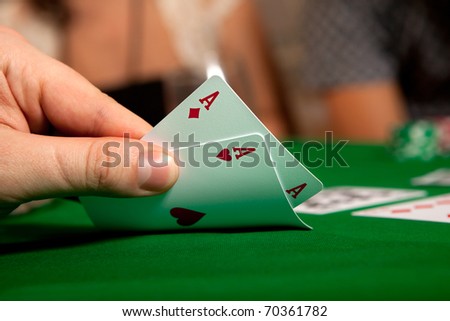 Pair of aces in his hand poker player.
