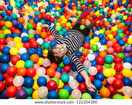 Little boy playing with balls