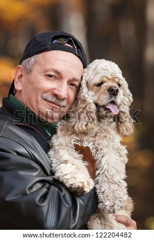 Old man with dog in the forest