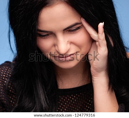 Unhappy young woman with bad headache