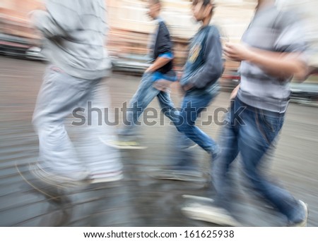 Group of young people hurrying about their business.  Intentional motion blur