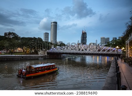 SINGAPORE - DECEMBER 9, 2014: Evening view of the Singapore River. The Singapore River Cruise is a tourist attraction in this former British colony.