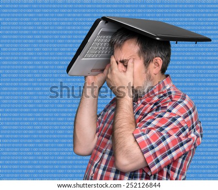 Digital world. Problems with computer. Middle aged stressed businessman with laptop on the head
