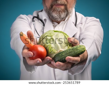 Health food concept. Doctor holding vegetables for healthy eating and healthy lifestyle. Focus on vegetables