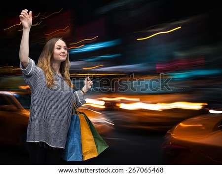Beautiful young woman with shopping bags during sales season in the big city