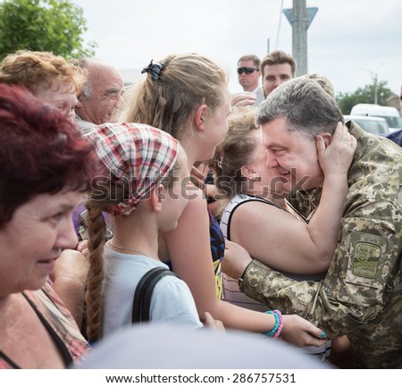 DONETSK REG, UKRAINE - Jun 11, 2015: President of Ukraine, Supreme Commander of Armed Forces of Ukraine Petro Poroshenko talks with people in the front-line cities